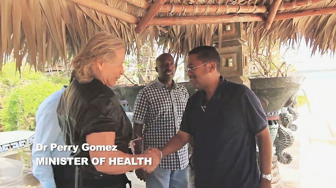 Dr Perry Gomez with Peter Nygard in the video.