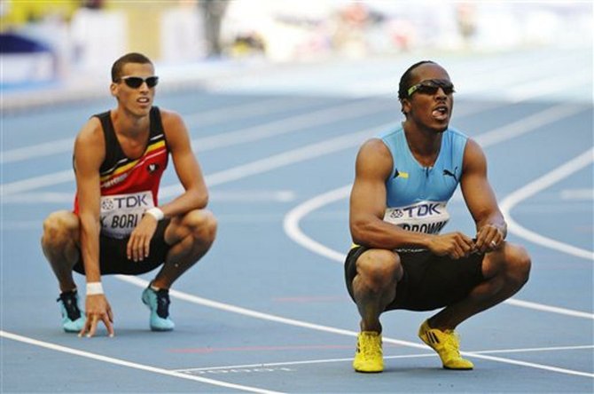 Chris Brown, right, and Belgium's Kevin Borlee look at the timing board after a men's 400-meter heat at the World Athletics Championships in the Luzhniki stadium in Moscow, Russia, Sunday, Aug. 11, 2013. (AP Photo/Anja Niedringhaus)