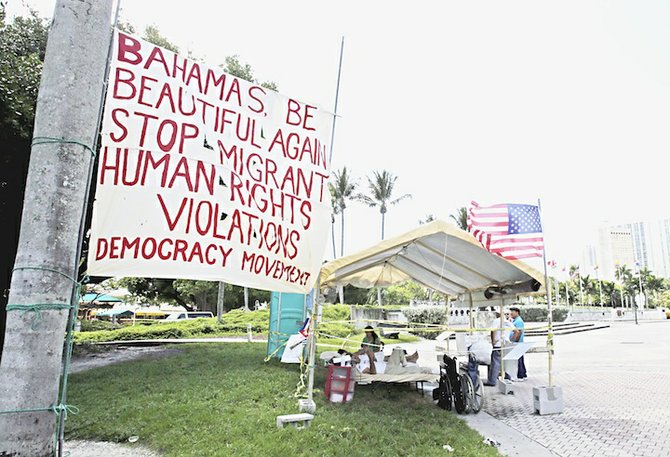 In this photo taken Wednesday, July 31, 2013, in Miami, Ramon Saul Sanchez, president of the Democracy Movement, and Jesus Alexis Gomez lie in beds during their hunger strike to protest the treatment of migrants in the Bahamas. (AP)
