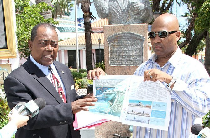 Rev CB Moss points out what is said to be an expanded area of land at Simms Point yesterday in a press conference held in Rawson Square. Also pictured is activist/filmmaker Celi Moss.