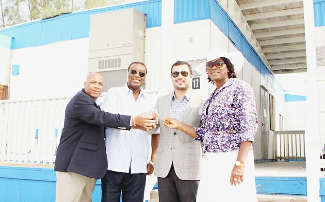 Pictured from left: Godfrey Toote, Algernon Allen, co-chair; Mike Maierle, construction manager; and Cynthia “Mother” Pratt, co-chair, receiving the keys to five office trailers being presented to Urban Renewal. 	
Photo: Patrick Hanna/BIS
