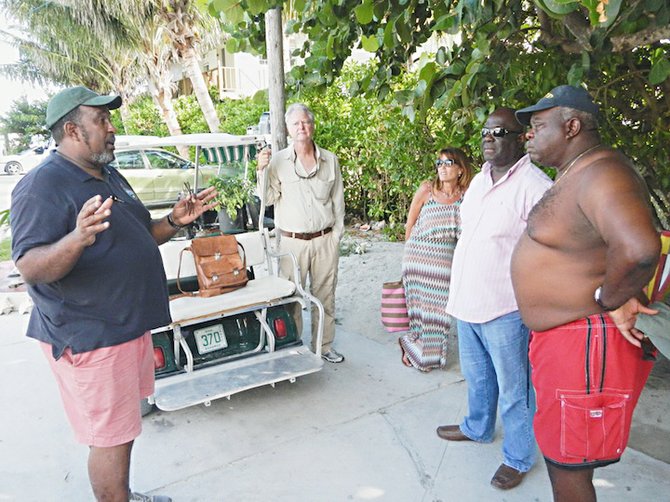 BNT executive director Eric Carey and BNT presiden Neil McKinney speaking to locals, including chief councillor Lloyd (Duda) Edgecombe, second from right.