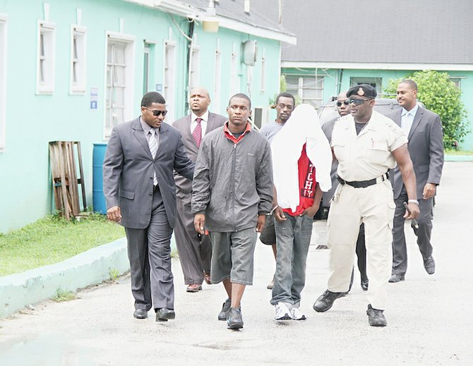 22-year-old Veron Hart (black jacket) and a 17-year-old were charged with the September 3 murder of Ned Joseph. At the back in the black shirt is 41-year-old Charles Williams, of Labour Street, who was charged in connection with the August 24th murder of Diontroy Moxey.