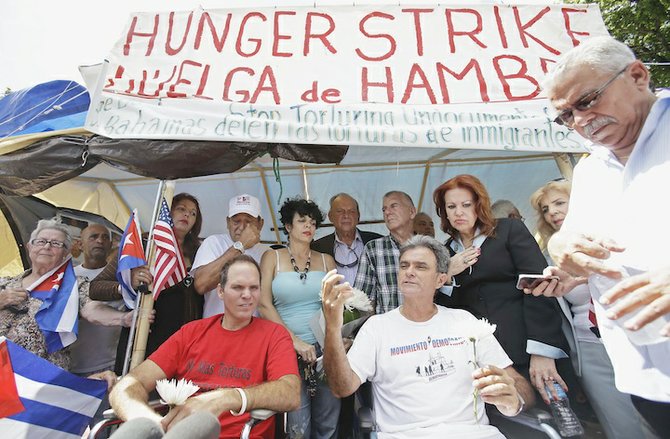 Cuban migrants Ramon Saul Sanchez, centre right, president of the Democracy Movement, and Jesus Alexis Gomez at the end of their hunger strike in Miami in August. 
