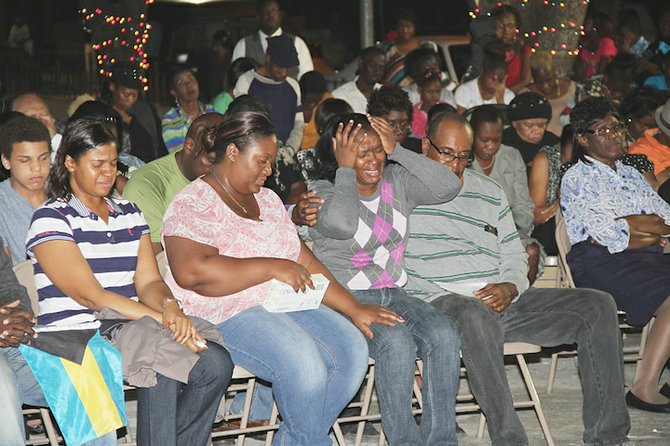 A mourner cries during the prayer vigil held in Fox Hill last night.