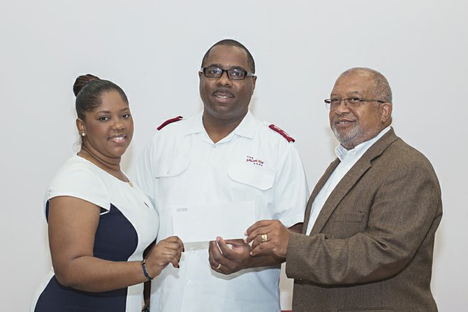 Commonwealth Bank’s Tameka Cooke, left; and Charles Knowles, far right, present cheque for $5,600 to Major Lester Ferguson, divisional commander of the Salvation Army. 
