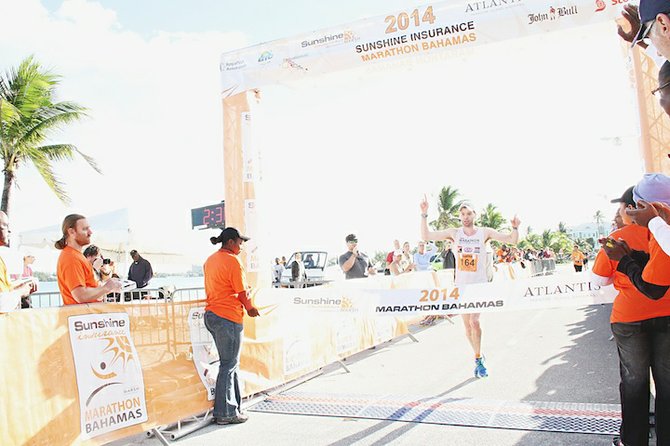 Justin Gilette, the top overall male winner, crossing the Marathon Bahamas finish line yesterday. He and his wife Melissa were the top male and female winners in the fifth installment of 26.2 mile run, which raises money to support cancer awareness, treatment and research.
Photo: Tim Clarke/Tribune Staff
