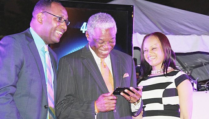 Senior public relations manager Jerome Sawyer, Minister of National Security Bernard Nottage and Manager of Mobile Product Development Alphanique Duncombe at last night’s launch. 