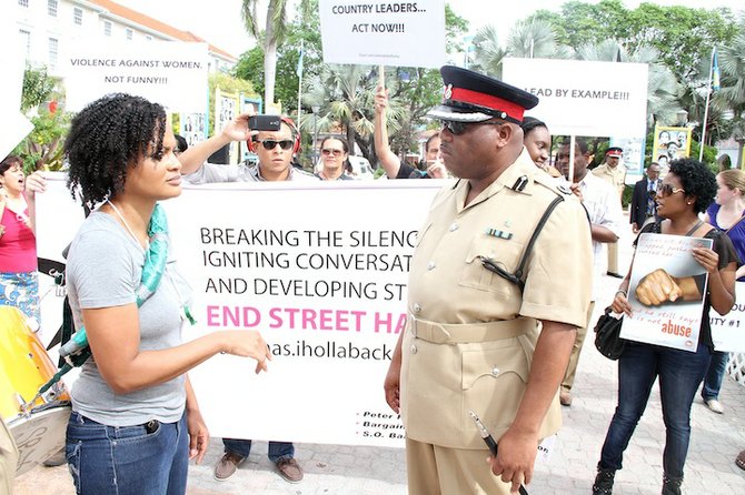 Terneille Burrows of Hollaback! speaks to a police officer at the protest.