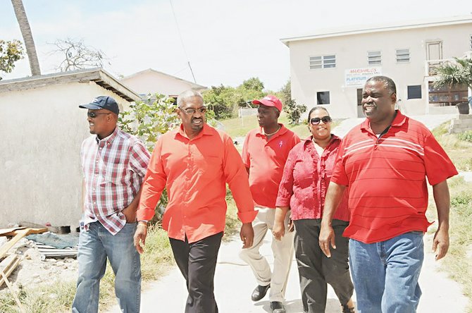 DR Minnis, second left, Joshua Sears, centre, and FNM deputy chair Brensil Rolle, far right, with Exuma residents.