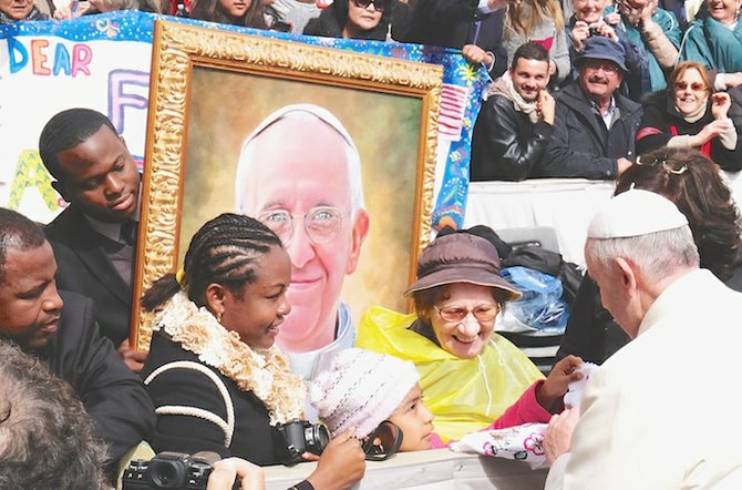 Jamaal Rolle carries his portrait as he comes face-to-face with the Pope himself.