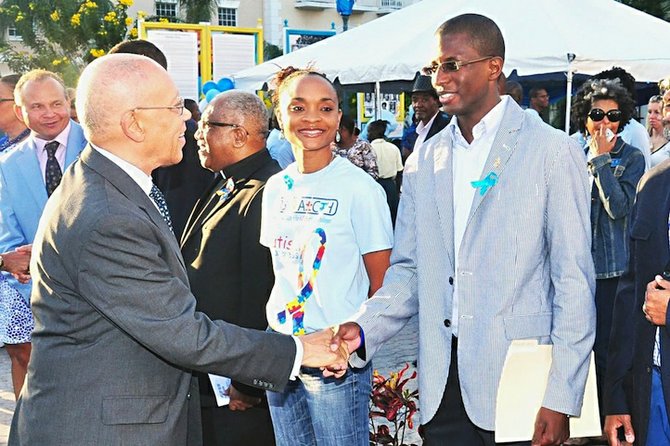 Governor General Sir Arthur Foulkes shakes the hand of an 'Autism Speaks' participant