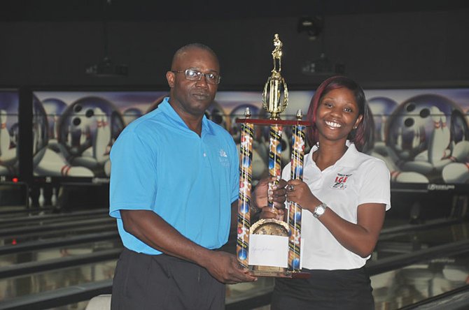 Xynea Johnson accepting her championship trophy from President Yule Hoyte.