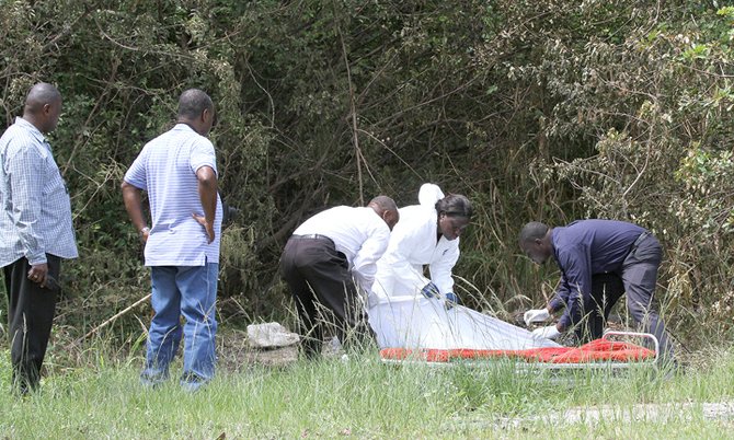 Police remove the body from the scene.