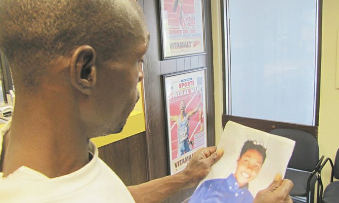 Anthony Francis holds a picture of his daughter, Adeisha, at The Tribune office.
