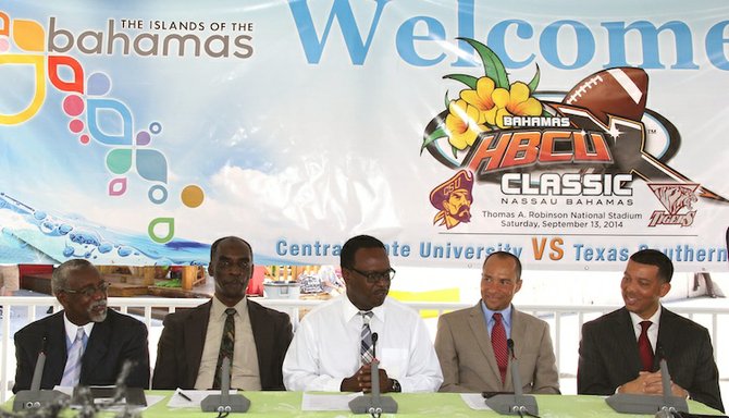 Curtis Symonds, Harrison Thompson, Jahan Culbreath and Charles McClelland listen as Minister of Sports Dr. Daniel Johnson makes remarks.