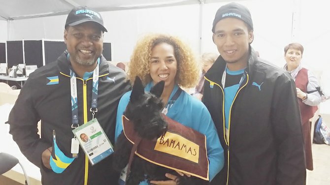 The Rahming family, comprising of father D’Arcy Sr, Cynthia and D’Arcy Jr. pose above with the Scottish Terrier that carried the Bahamas name during the Athletes March Pass at the opening ceremonies of the 20th Commonwealth Games on Wednesday night at the famous Celtic Park in Glasgow, Scotland.