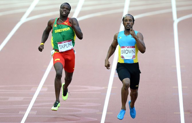 Chris Brown and Grenada's Bralon Taplin in the Men's 400m Semi Final at Hampden Park. (AP)