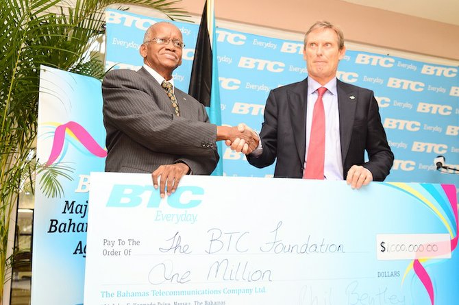 Cable and Wireless Chairman Phil Bentley (right) presents a $1 million cheque to the BTC Foundation. 
Photo: Lamond Johnson/Tribune staff