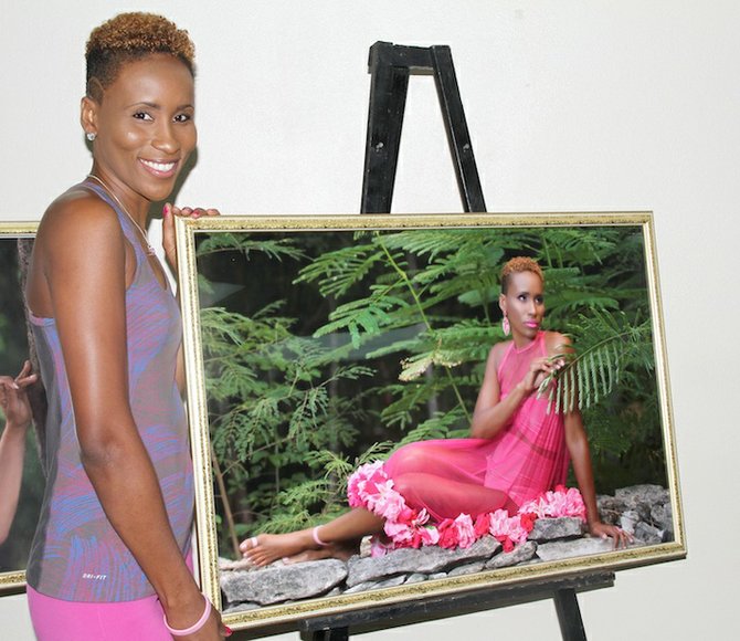 Rika Cargill poses with her portrait which will be used for the month of September in the 2015 calendar for the Bahamas Breast Cancer Initiative Foundation. The group is hoping to raise $150,000 this month to go towards research and support. Photo: Tim Clarke/Tribune Staff
