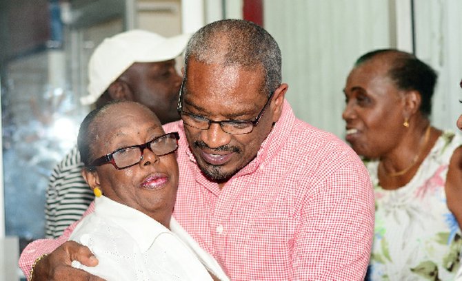 A hug from a supporter for FNM leader Dr Hubert Minnis.