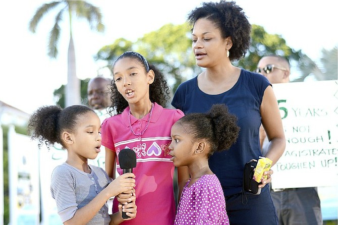 ORGANISER Terneille ‘TaDa’ Burrows with the N-Squad Group singing the song ‘Something Inside So Strong’ during yesterday’s protest.
Photo/Shawn Hanna/Tribune staff