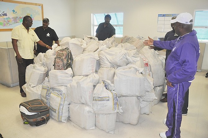 Officers with the mammoth $6.2m drug haul found in Grand Bahama. Photo: Vandyke Hepburn/BIS

