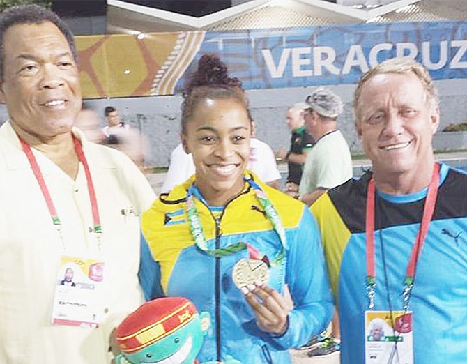 
GOLDEN GIRL: CAC Games’ gold medallist Arianna Vanderpool-Wallace with BOC president Wellington Miller and BSF’s head coach Andy Knowles.

