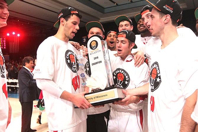 Wisconsin players hold their trophy after defeating Oklahoma 69-56 in the championship match of the Battle 4 Atlantis basketball tournament last night.
(AP Photo/Tim Aylen)
