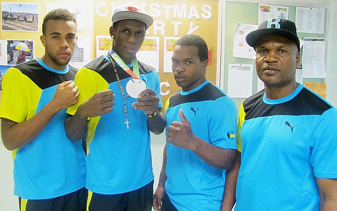 SILVER GLORY: Shown (l-r) are Rashield Williams, Carl Hield, Godfrey Pinder and coach Andre Seymour.

