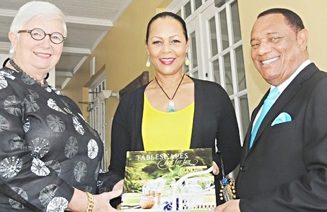 Art collector Dawn Davies presents a copy of her latest book TABLESCAPES: Just For Fun to Prime Minister Perry Christie and Bernadette Christie at the National Art Gallery of the Bahamas. 
Photo: Peter Ramsay/BIS
