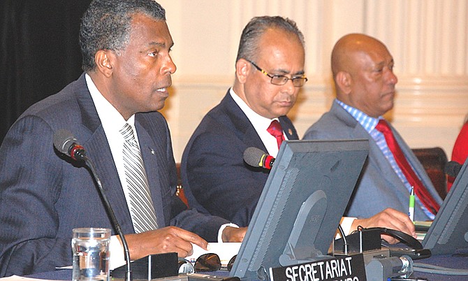 Foreign Affairs and Immigration Minister Fred Mitchell (left) addressing a Special Permanent Council Meeting of the Organisation of American States (OAS) in Washington, DC, yesterday. At centre is OAS Assistant Secretary General Albert Ramdin and at right is Ambassador of Guyana Bayney Karran.
