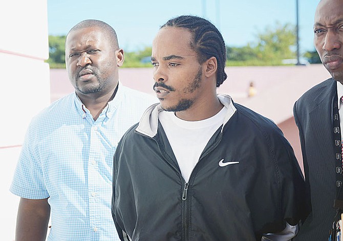 Shirvon Stubbs, right, pictured outside court yesterday. He is accused of the murder of teenager Jaquan Rolle and the attempted murder of Rolle’s younger brother, 14-year-old Ashton Dorsett. 
Photo: Shawn Hanna/Tribune Staff
