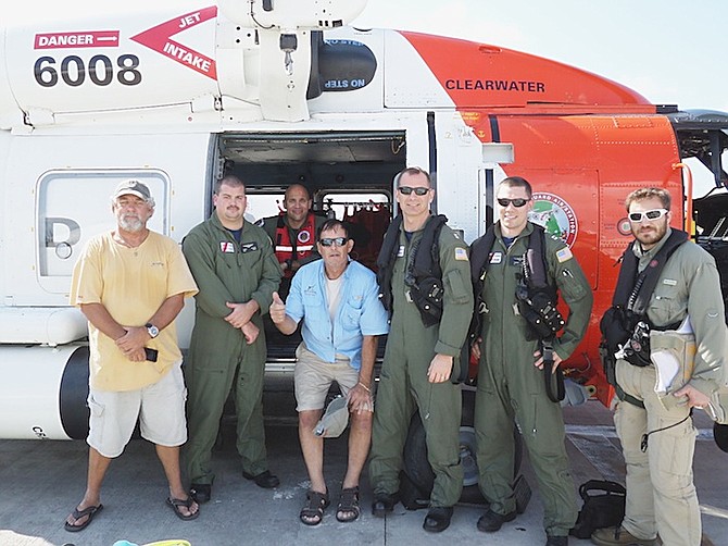 The Coast Guard crew with the two rescued men. 