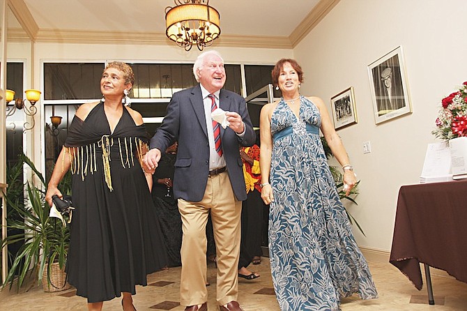 Sir Jack Hayward opening the remodeled Regency Theatre with Andrea Gottlieb, left, past president, and Paula Fingland, then president and chairman of the Remodel Committee.
