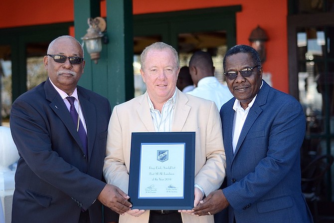 Freddie Lightbourne, General Manager of the Poop Deck, (centre) receives his award from Michael Symonette, SKAL President, and Earlston McPhee, SKAL Secretary. Photos Shawn Hanna
