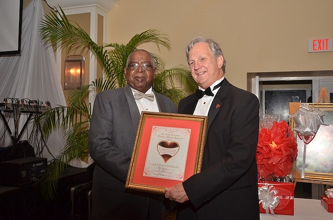 Chairman of the Sassoon Heart Foundation R E Barnes (right) presents A Bismark Coakley with this year’s Lady Sassoon Golden Heart award.
(Photo by Jamal Jones)

