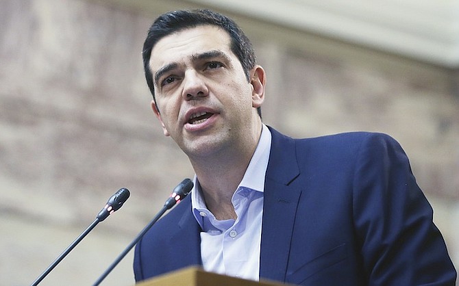 Greece’s Prime Minister Alexis Tsipras delivers a speech to his party’s lawmakers at the parliament in Athens, yesterday. 