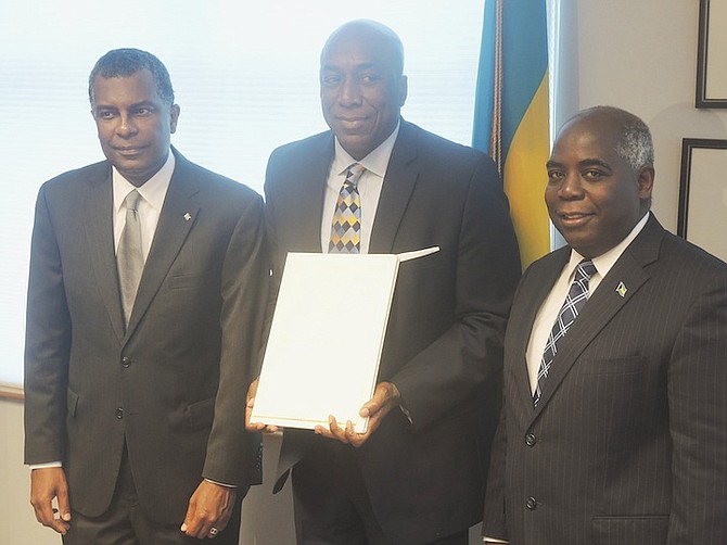 Lynden Rose, centre, the new Honorary Consul to Houston, flanked by Minister of Foreign Affairs Fred Mitchell, left, and Deputy Prime Minister Philip Davis.