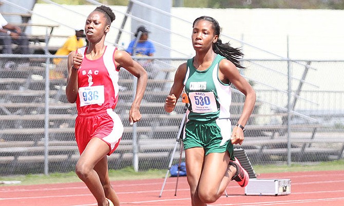 FAST TRACK: Queen’s College Comets streaked ahead of the field yesterday on the opening day of the Bahamas Association of Independent Secondary Schools Track and Field Championships at the original Thomas A Robinson National Stadium.  