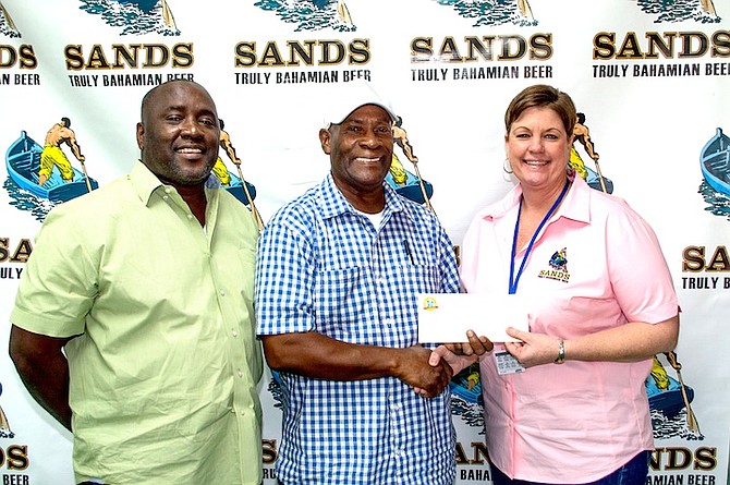 Bahamian Brewery and Beverages’ Sales manager Lynden Johnson and Marketing Manager Michelle Fox make the presentation to National Family Island Regatta commodore Danny Strachan.	  Photo: Blas Ingraham