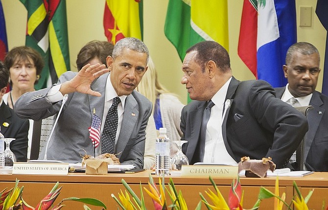 US President Barack Obama talks with Prime Minister Perry Christie at the summit with Caribbean Community (CARICOM) leaders yesterday in Kingston, Jamaica. The president said that will he soon decide whether to remove Cuba from the US list of state sponsors of terrorism now that the State Department has finished a review on the question as part of the move to reopen diplomatic relations with the island nation.Photo: Pablo Martinez Monsivais/AP