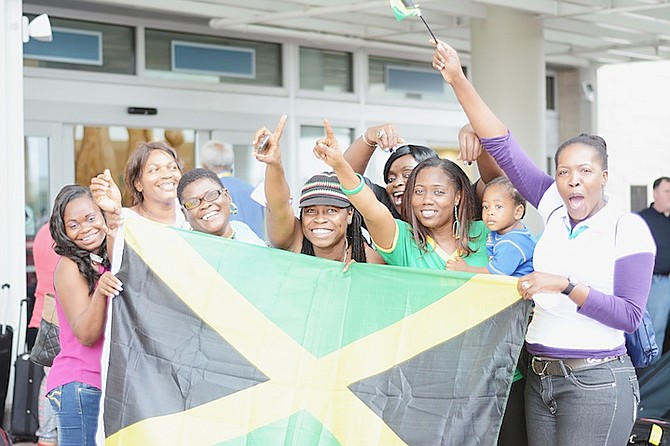 FANS of Team Jamaica cheer for their athletes yesterday outside the Lynden Pindling International Airport.
