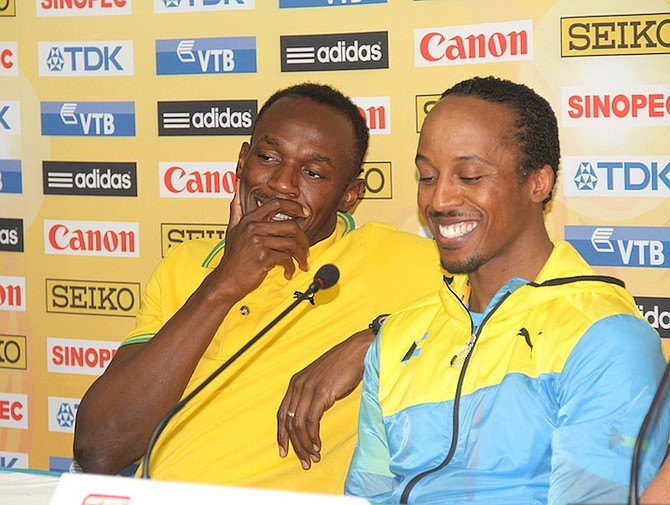 Chris Brown shares a joke with Usain Bolt on Friday.