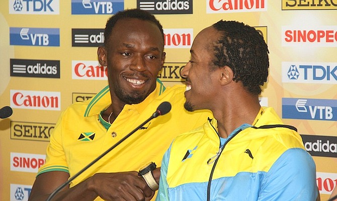 Usain Bolt with Chris Brown at Friday's press conference. Photo: Tim Clarke/Tribune staff
