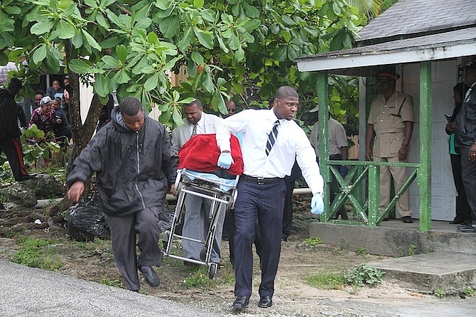 Police remove the body from the scene. Photo: Tim Clarke/Tribune staff