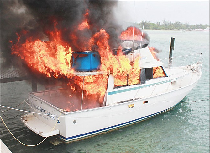 The boat in flames at Dick’s Point yesterday. Photo: Ronald Lightbourn