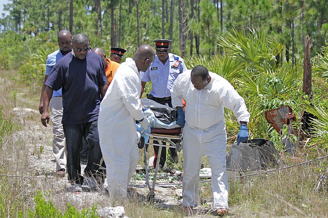 The body of a young woman is removed from the Coral Harbour area yesterday. Photo: Tim Clarke/Tribune Staff