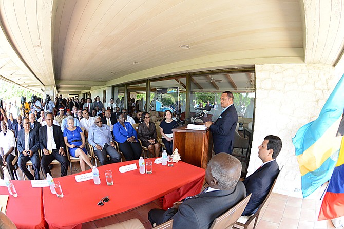 Prime Minister Perry Christie, standing at right, at the Cotton Bay deal signing. Photo: Peter Ramsay/BIS
