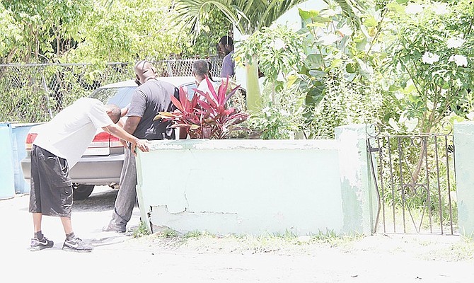 Family members of 21-year-old Georgette Rahming in shock at the scene of yesterday’s shooting. Photo: Tim Clarke/Tribune Staff